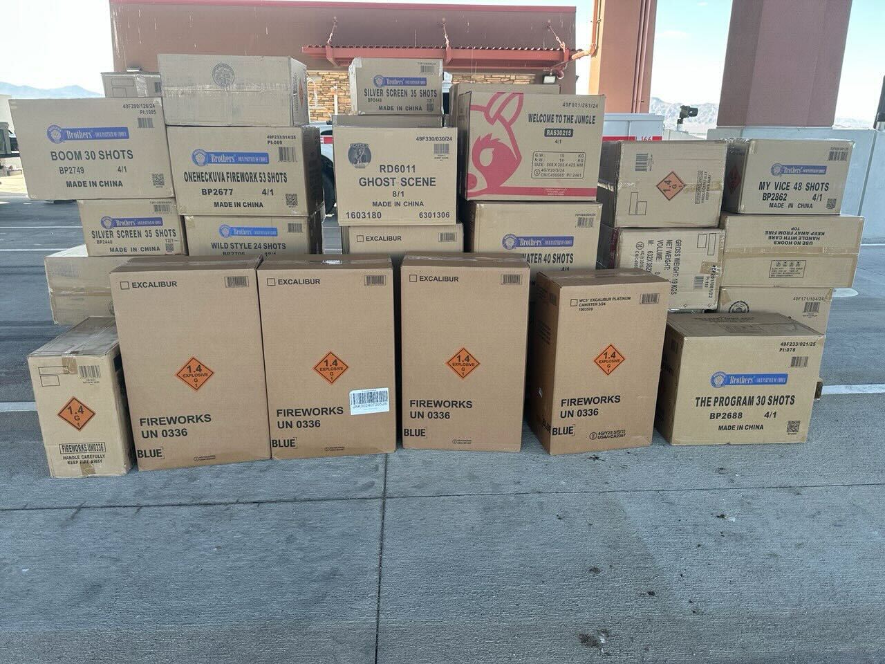 Dozens of stacked boxes labeled as fireworks are displayed at an inspection site.