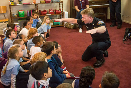 Officer teaching students