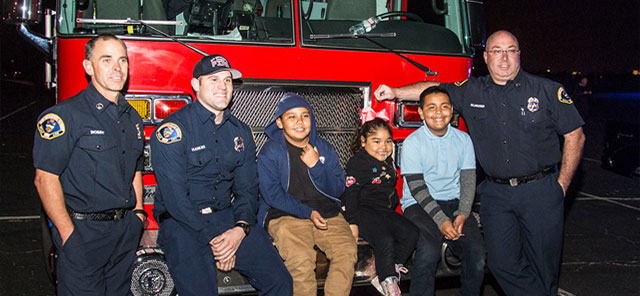 firefighters and kids at toy drive