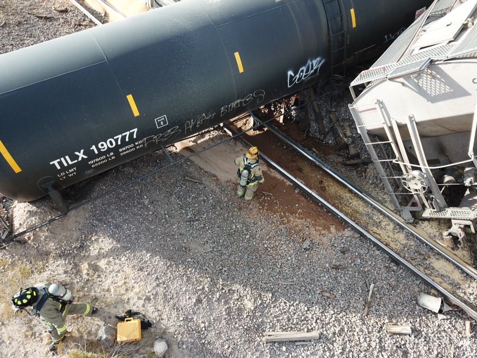 firefighter next to derailed container