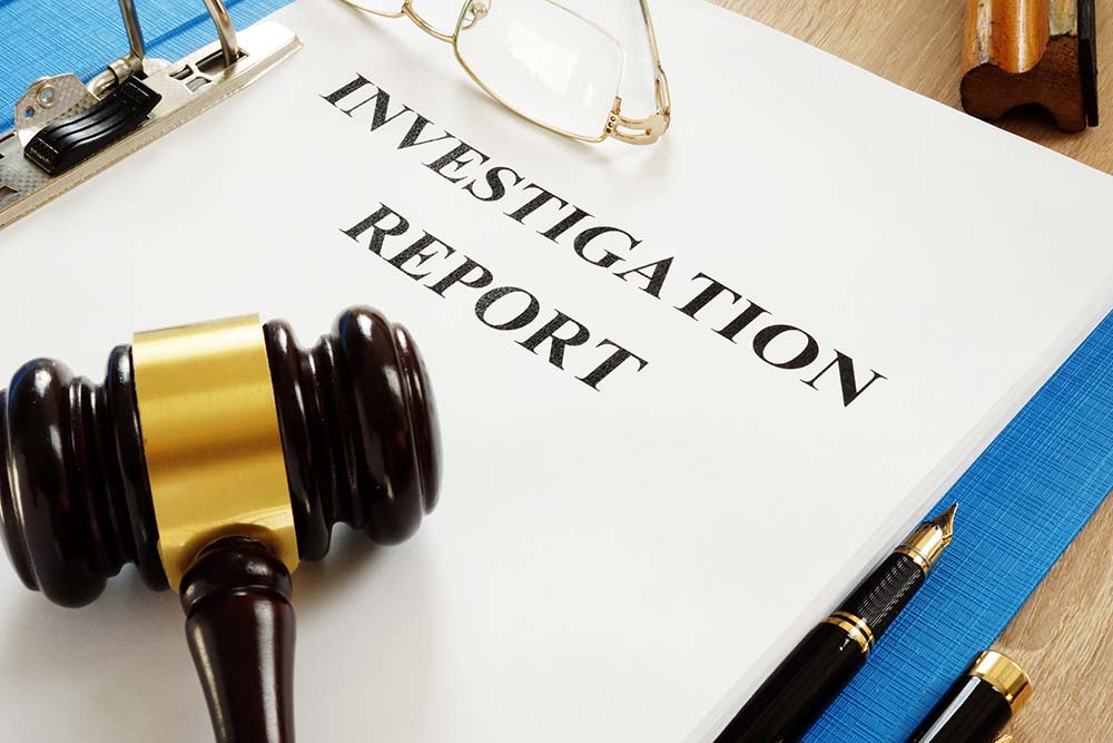Investigation report and gavel on a table.