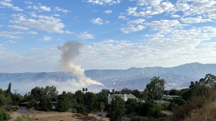 Smoke rises from the Line Fire burning in the San Bernardino Mountains on a clear September morning
