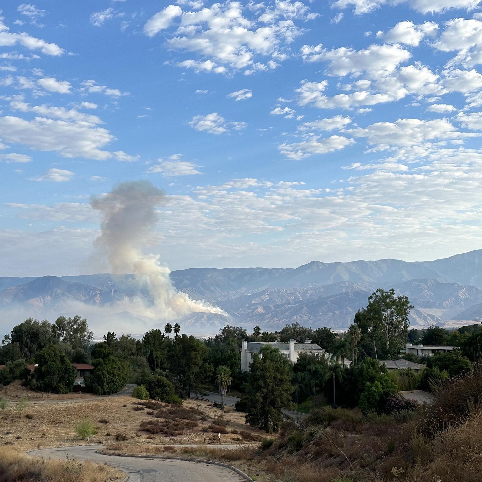 Smoke rises from the Line Fire burning in the San Bernardino Mountains on a clear September morning