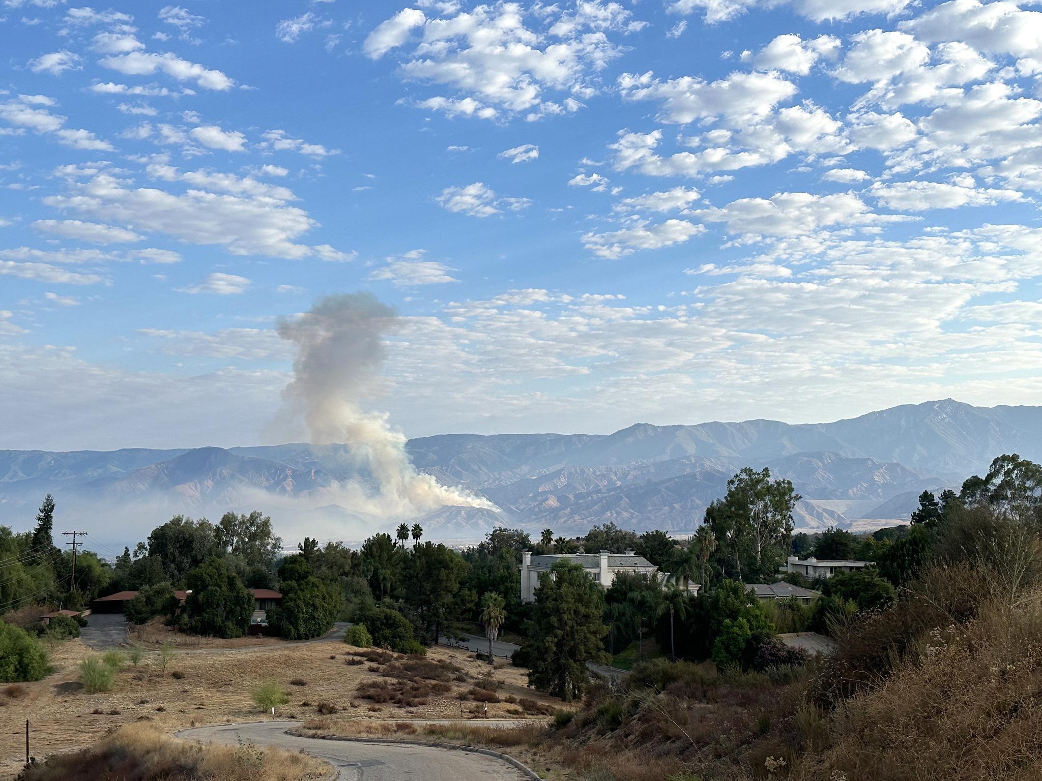 Smoke rises from the Line Fire burning in the San Bernardino Mountains on a clear September morning